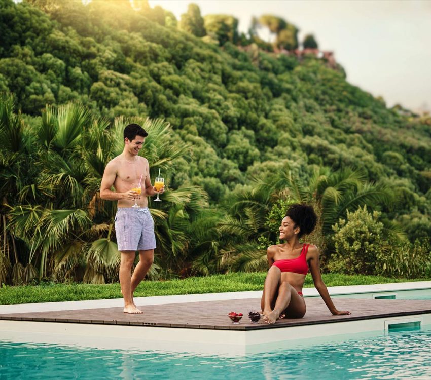 couple-relaxing-by-the-pool-in-a-tropical-resort-2025-03-07-07-33-33-HEW72ZC