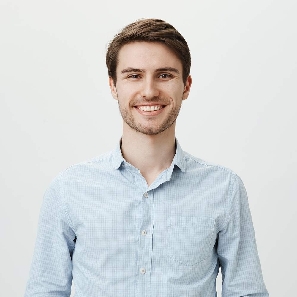 smiling-brunette-man-poses-in-a-light-shirt-2026-01-05-05-13-24-utc