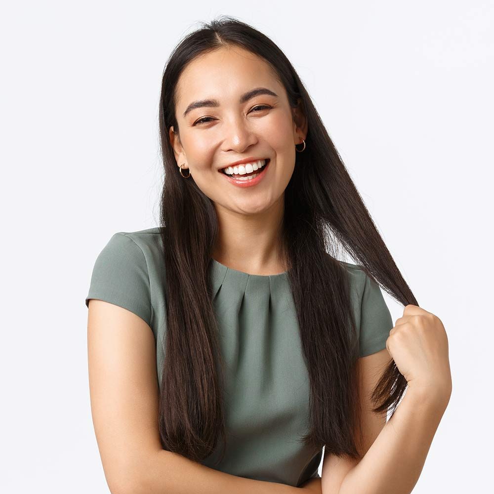 smiling-woman-in-green-dress-twirls-hair-strand-2026-01-08-07-15-18-utc
