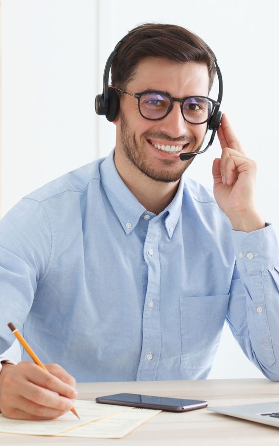 smiling-male-customer-service-worker-sitting-with-2023-11-27-05-29-53-M7BJ96J