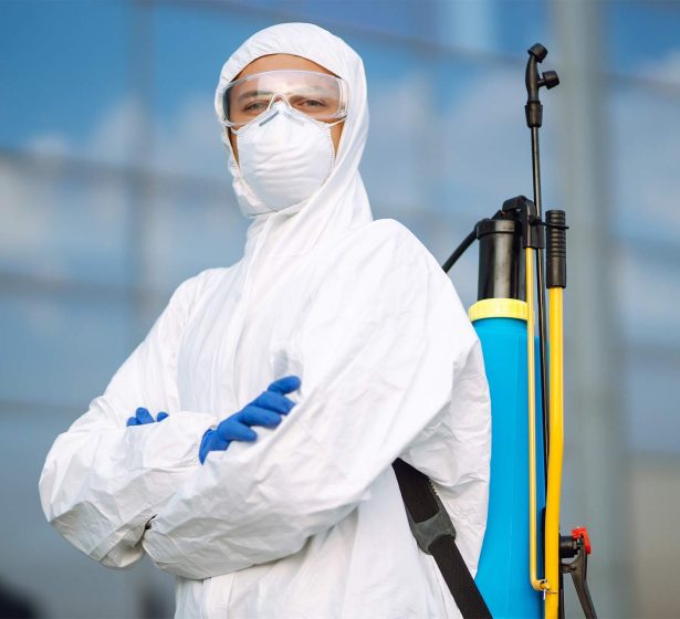 disinfecting-to-prevent-covid-19-man-in-protectiv-2025-03-05-05-32-49-AYUVLQG